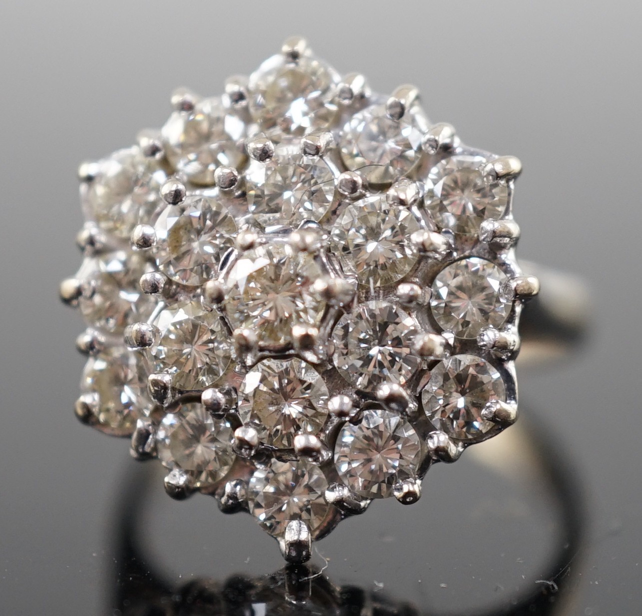 An 18ct white gold and diamond set hexagonal cluster ring